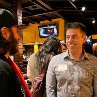 Two alums talking at the social.